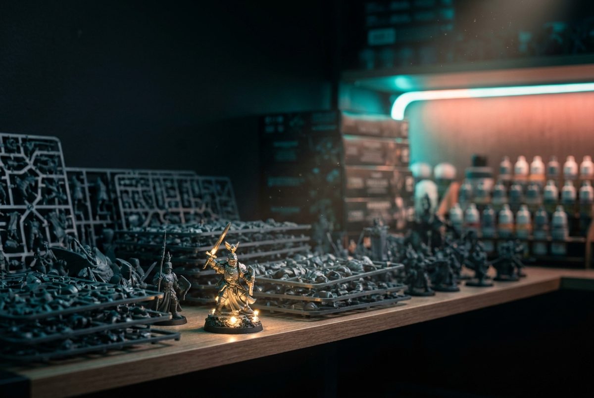 A collection of unpainted miniatures waiting on a hobby shelf